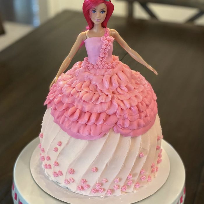 Doll cake with a ruffled pink buttercream gown